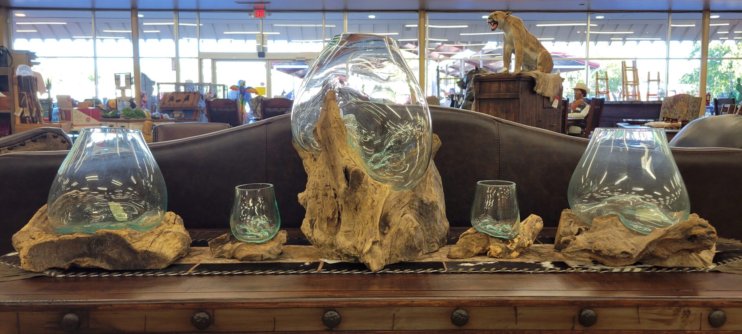Driftwood with blown glass bowls in various sizes.