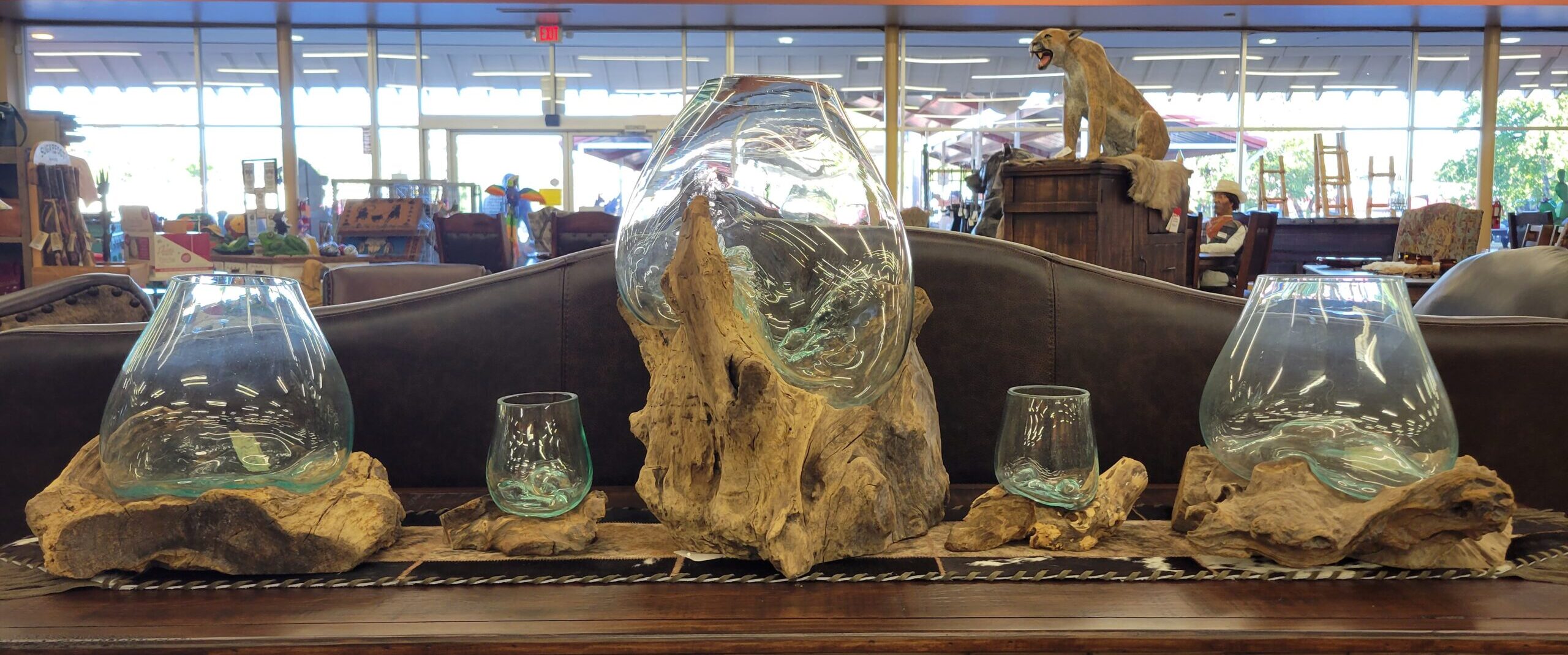 Driftwood with blown glass bowls in various sizes.