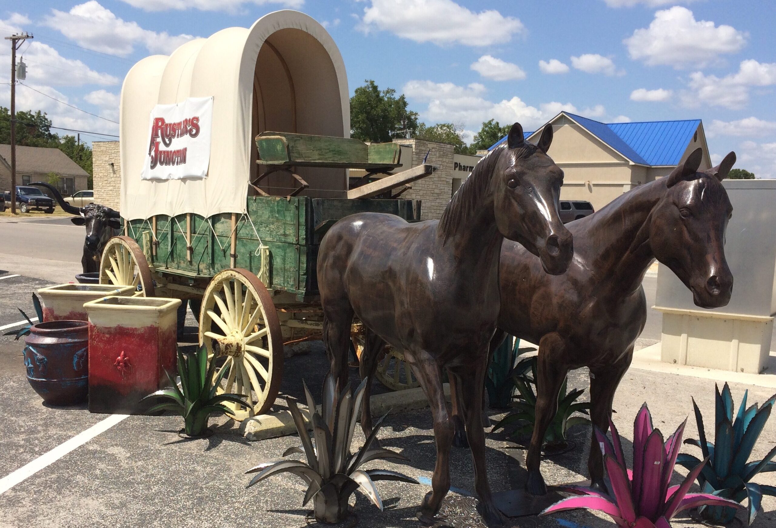 Horse statues pulling wagon at Rustler's Junction in Lampasas, TX. Don't miss out on our Always Awesome deliveries!